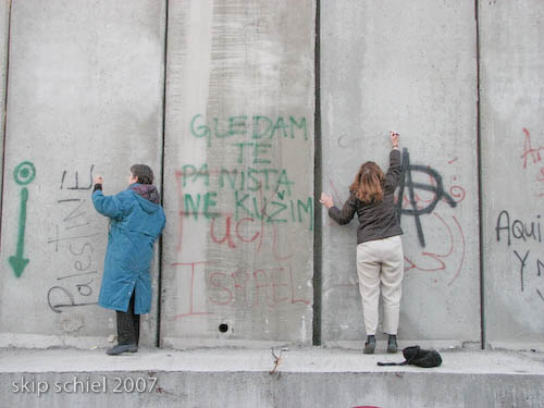 Two Cambridge delegates signing the Wall
