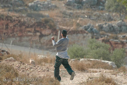 Hurling a rock with a slingshot